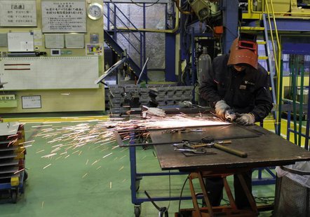 A worker cuts a metal at a sheet metal processing company Yamada Manufacturing in Daito, Osaka prefecture, December 10, 2013. REUTERS/Yoko K A worker cuts a metal at a sheet metal processing company Yamada Manufacturing in Daito, Osaka prefecture, December 10, 2013. REUTERS/Yoko K