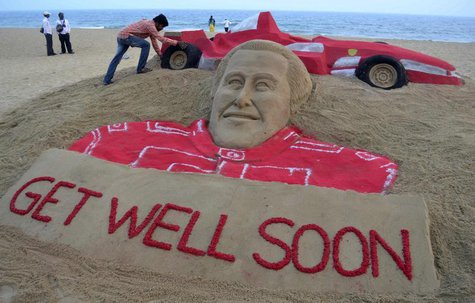 Indian sand artist Sudarshan Pattnaik works on a sand sculpture of seven-times Formula One world champion Michael Schumacher to wish him a s Indian sand artist Sudarshan Pattnaik works on a sand sculpture of seven-times Formula One world champion Michael Schumacher to wish him a s