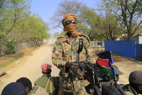 A South Sudan army soldier mans a machine gun, that has been mounted onto a truck, as it drives through a street in Malakal town, 497 km (30 A South Sudan army soldier mans a machine gun, that has been mounted onto a truck, as it drives through a street in Malakal town, 497 km (30