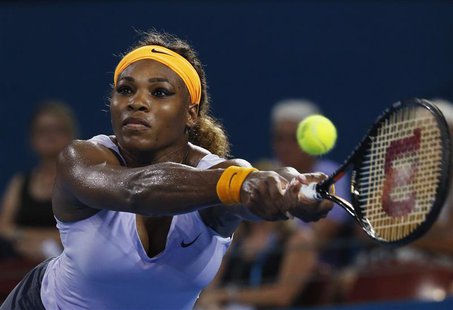 Serena Williams of the U.S. reaches for return to Maria Sharapova of Russia during their women's singles semi final match at the Brisbane In Serena Williams of the U.S. reaches for return to Maria Sharapova of Russia during their women's singles semi final match at the Brisbane In