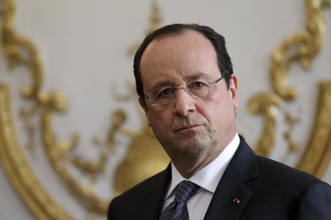 French President Francois Hollande listens to the speech of French Prime Minister during a new year ceremony with members of the government French President Francois Hollande listens to the speech of French Prime Minister during a new year ceremony with members of the government