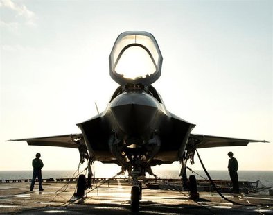 The flight deck crew secures an F-35B Lighting II aircraft aboard the amphibious assault ship USS Wasp following testing in this handout pho The flight deck crew secures an F-35B Lighting II aircraft aboard the amphibious assault ship USS Wasp following testing in this handout pho