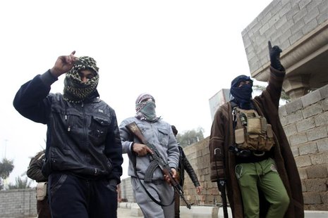 Gunmen fighters walk in the streets of the city of Falluja, 50 km (31 miles) west of Baghdad January 3, 2014. REUTERS/Stringer Gunmen fighters walk in the streets of the city of Falluja, 50 km (31 miles) west of Baghdad January 3, 2014. REUTERS/Stringer