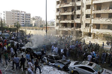 Soldiers, policemen and medical personnel gather at the site of explosions near the Iranian embassy (L) in Beirut November 19, 2013. REUTERS Soldiers, policemen and medical personnel gather at the site of explosions near the Iranian embassy (L) in Beirut November 19, 2013. REUTERS