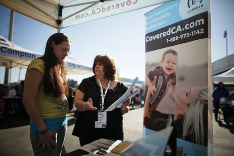 Maria Franco (R) explains health insurance to Violet Lucas-Barajas, 28, at an event to inform people about the Affordable Care Act and donat Maria Franco (R) explains health insurance to Violet Lucas-Barajas, 28, at an event to inform people about the Affordable Care Act and donat
