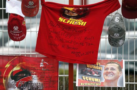 Caps, flags and a shirt marking the 45th birthday of seven-times former Formula One world champion Michael Schumacher are placed outside his Caps, flags and a shirt marking the 45th birthday of seven-times former Formula One world champion Michael Schumacher are placed outside his