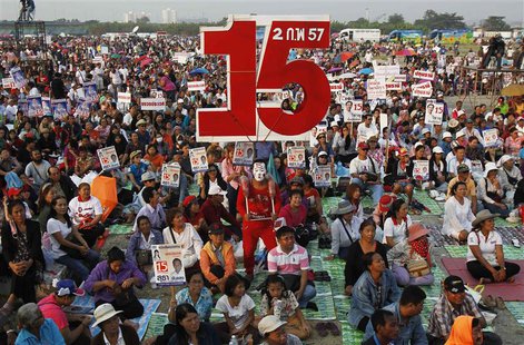 A supporter of Puea Thai party carries a sign with the number 15, referring to the party's number during upcoming elections, poses for photo A supporter of Puea Thai party carries a sign with the number 15, referring to the party's number during upcoming elections, poses for photo