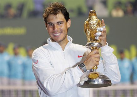 Rafael Nadal of Spain holds his trophy after winning the Qatar Open final tennis match in Doha January 4, 2014. REUTERS/Ahmed Jadallah Rafael Nadal of Spain holds his trophy after winning the Qatar Open final tennis match in Doha January 4, 2014. REUTERS/Ahmed Jadallah
