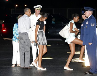 U.S. President Barack Obama (2nd L) and his daughters Malia (C) and Sasha (3rd R) board Air Force One upon their departure from Honolulu to U.S. President Barack Obama (2nd L) and his daughters Malia (C) and Sasha (3rd R) board Air Force One upon their departure from Honolulu to
