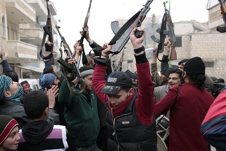 Free Syrian Army fighters cheer during an anti-Syrian regime protest in Maarat Al-Nouman, Idlib, January 3, 2014. Picture taken January 3, 2 Free Syrian Army fighters cheer during an anti-Syrian regime protest in Maarat Al-Nouman, Idlib, January 3, 2014. Picture taken January 3, 2