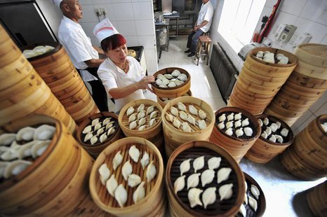 A cook arranges baskets of newly-made dumplings at a restaurant in Shenyang, Liaoning province July 13, 2013. REUTERS/Stringer A cook arranges baskets of newly-made dumplings at a restaurant in Shenyang, Liaoning province July 13, 2013. REUTERS/Stringer