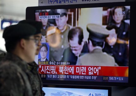 South Korean soldiers walk past a television showing reports on the execution of Jang Song Thaek, who is North Korean leader Kim Jong Un's u South Korean soldiers walk past a television showing reports on the execution of Jang Song Thaek, who is North Korean leader Kim Jong Un's u