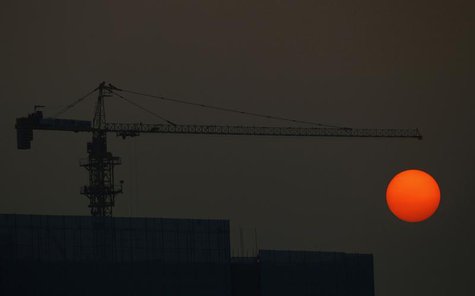 The sun sets behind a construction site in Guangzhou, Guangdong province, January 3, 2014. REUTERS/Alex Lee The sun sets behind a construction site in Guangzhou, Guangdong province, January 3, 2014. REUTERS/Alex Lee