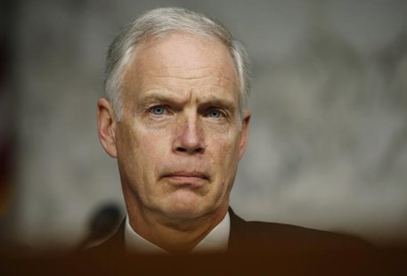 U.S. Senator Ron Johnson (R-WI) listens to Secretary of State Hillary Clinton respond to questions about the September attack on U.S. diplom U.S. Senator Ron Johnson (R-WI) listens to Secretary of State Hillary Clinton respond to questions about the September attack on U.S. diplom