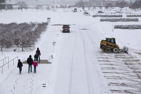People walk in the Milwaukee Art Museum, as a winter storm moves across the midwest, in Milwaukee, Wisconsin December, 22, 2013. REUTERS/Dar People walk in the Milwaukee Art Museum, as a winter storm moves across the midwest, in Milwaukee, Wisconsin December, 22, 2013. REUTERS/Dar
