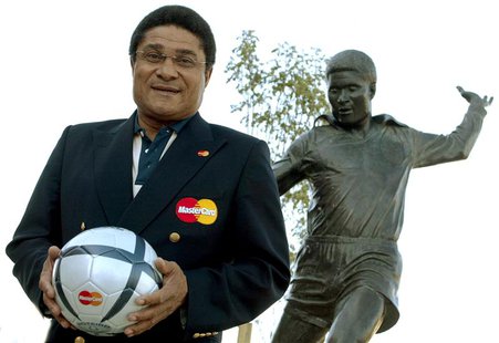Portuguese soccer player Eusebio holds a soccer ball and poses in front of his statue at the entrance of the Luz Stadium in Lisbon in this J Portuguese soccer player Eusebio holds a soccer ball and poses in front of his statue at the entrance of the Luz Stadium in Lisbon in this J