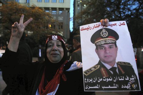 An Egyptian holds an image of Egypt's Army Chief General Abdel Fattah al-Sisi during a protest against what they say is Qatar's backing of o An Egyptian holds an image of Egypt's Army Chief General Abdel Fattah al-Sisi during a protest against what they say is Qatar's backing of o