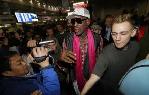 Former NBA basketball player Dennis Rodman (C) is surrounded by journalists as he arrives at the Beijing Capital International Airport to le Former NBA basketball player Dennis Rodman (C) is surrounded by journalists as he arrives at the Beijing Capital International Airport to le