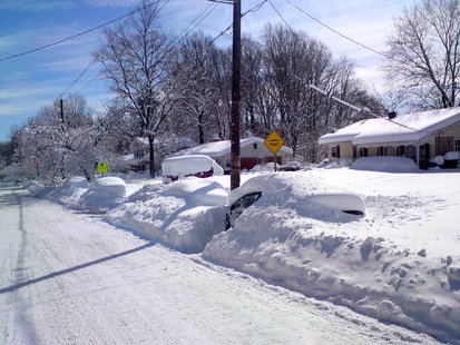 A car is covered in snow. A car is covered in snow.