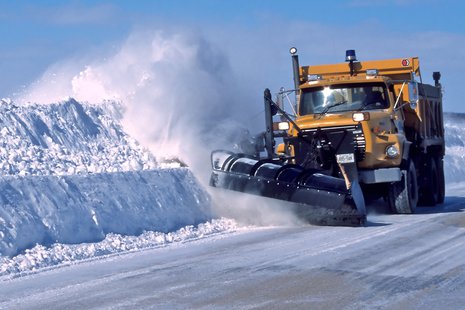 A snowplow on a highway. A snowplow on a highway.