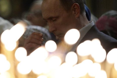Russia's President Vladimir Putin gestures as he attends the Orthodox Christmas service at the Holy Face of Christ the Savior Church in the Russia's President Vladimir Putin gestures as he attends the Orthodox Christmas service at the Holy Face of Christ the Savior Church in the