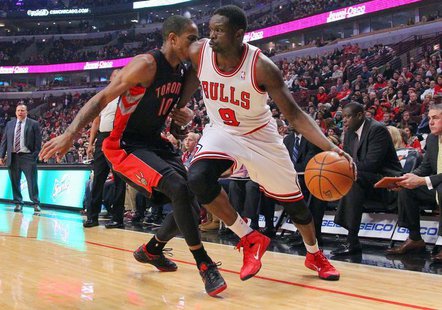 Dec 31, 2013; Chicago, IL, USA; Chicago Bulls small forward Luol Deng (9) is defended by Toronto Raptors shooting guard DeMar DeRozan (10) d Dec 31, 2013; Chicago, IL, USA; Chicago Bulls small forward Luol Deng (9) is defended by Toronto Raptors shooting guard DeMar DeRozan (10) d