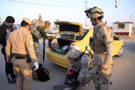 Iraqi security personnel search the vehicle of a resident, who is fleeing the violence in Falluja and Ramadi, at a checkpoint in Ein Tamarm, Iraqi security personnel search the vehicle of a resident, who is fleeing the violence in Falluja and Ramadi, at a checkpoint in Ein Tamarm,