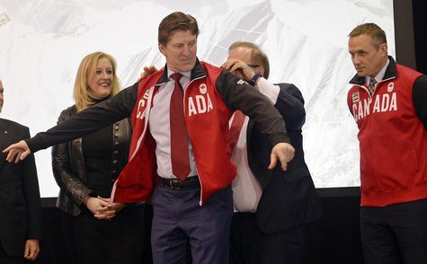 Canada's Men's Olympic Ice Hockey Team executive director Steve Yzerman (R) and Minister of Transport Lisa Raitt (L) look on as head coach M Canada's Men's Olympic Ice Hockey Team executive director Steve Yzerman (R) and Minister of Transport Lisa Raitt (L) look on as head coach M