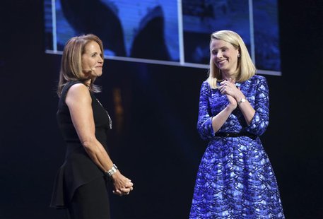 Yahoo CEO Marissa Mayer (R) greets journalist Katie Couric on stage during Mayer's keynote speech at the annual Consumer Electronics Show (C Yahoo CEO Marissa Mayer (R) greets journalist Katie Couric on stage during Mayer's keynote speech at the annual Consumer Electronics Show (C
