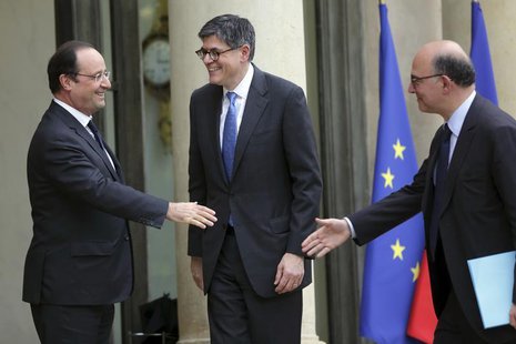 French President Francois Hollande (L) welcomes U.S. Treasury Secretary Jack Lew (C) and French Finance Minister Pierre Moscovici (R) at the French President Francois Hollande (L) welcomes U.S. Treasury Secretary Jack Lew (C) and French Finance Minister Pierre Moscovici (R) at the