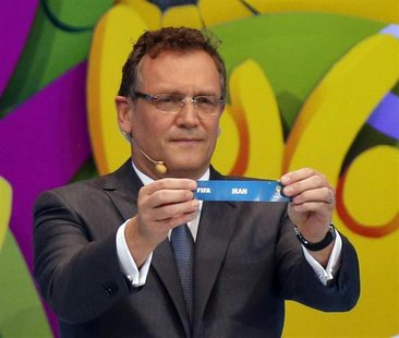 FIFA Secretary General Jerome Valcke holds the slip showing "Iran" during the draw for the 2014 World Cup at the Costa do Sauipe resort in S FIFA Secretary General Jerome Valcke holds the slip showing "Iran" during the draw for the 2014 World Cup at the Costa do Sauipe resort in S