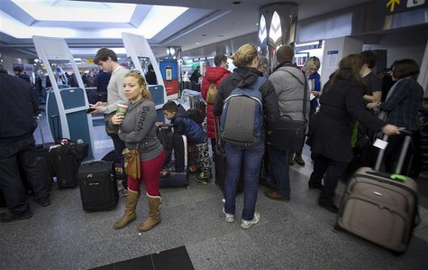 People line up for information about their flights at La Guardia airport in New York January 6, 2014. REUTERS/Carlo Allegri People line up for information about their flights at La Guardia airport in New York January 6, 2014. REUTERS/Carlo Allegri