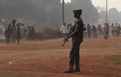 A Chadian soldier from the African Union peacekeeping mission to Central African Republic (MISCA) takes a strategic position along a combata A Chadian soldier from the African Union peacekeeping mission to Central African Republic (MISCA) takes a strategic position along a combata