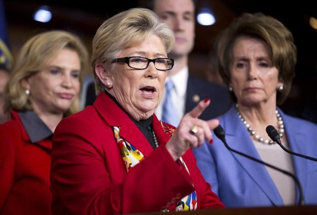 U.S. Representative Carolyn McCarthy (D-NY) speaks as House Minority Leader Nancy Pelosi (R) (D-CA) listens during a news conference to disc U.S. Representative Carolyn McCarthy (D-NY) speaks as House Minority Leader Nancy Pelosi (R) (D-CA) listens during a news conference to disc