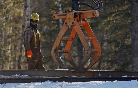 A CN worker looks on while working on the railway in Plaster Rock, New Brunswick, January 8, 2014. REUTERS/Mathieu Belanger A CN worker looks on while working on the railway in Plaster Rock, New Brunswick, January 8, 2014. REUTERS/Mathieu Belanger