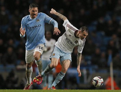 Manchester City's Javi Garcia (L) challenges West Ham United's Matt Taylor during their English League Cup semi-final first leg soccer match Manchester City's Javi Garcia (L) challenges West Ham United's Matt Taylor during their English League Cup semi-final first leg soccer match