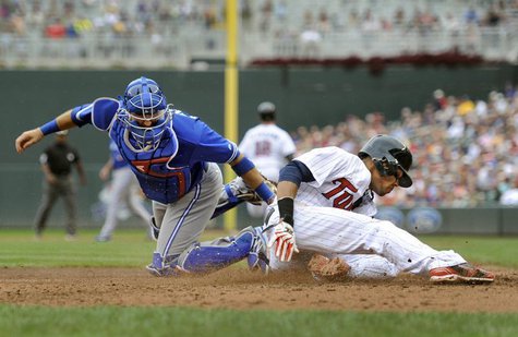 Toronto Blue Jays catcher J.P. Arencibia (L) tags out Minnesota Twins Pedro Florimon at home in the sixth inning of their MLB American Leagu Toronto Blue Jays catcher J.P. Arencibia (L) tags out Minnesota Twins Pedro Florimon at home in the sixth inning of their MLB American Leagu