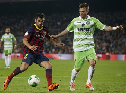 Barcelona's Sergi Roberto fights for the ball with Getafe's Alexis Ruano (R) during their Spanish King's Cup match at Camp Nou stadium in Ba Barcelona's Sergi Roberto fights for the ball with Getafe's Alexis Ruano (R) during their Spanish King's Cup match at Camp Nou stadium in Ba