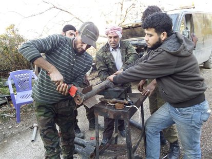 Free Syrian Army fighters prepare homemade rockets in Latakia countryside January 7, 2014. REUTERS/Khattab Abdulaa Free Syrian Army fighters prepare homemade rockets in Latakia countryside January 7, 2014. REUTERS/Khattab Abdulaa