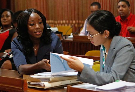 Jamaica's Olympic sprinter Sherone Simpson (L), who tested positive for doping at the Jamaican Championships in 2013, talks with her attorne Jamaica's Olympic sprinter Sherone Simpson (L), who tested positive for doping at the Jamaican Championships in 2013, talks with her attorne
