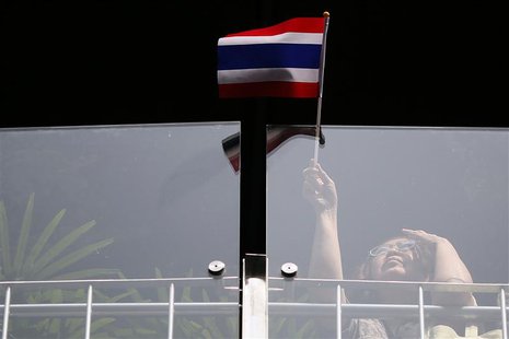 A woman waves a flag as she joins other anti-government protesters gathering in Bangkok's business district January 8, 2014. REUTERS/Damir S A woman waves a flag as she joins other anti-government protesters gathering in Bangkok's business district January 8, 2014. REUTERS/Damir S