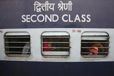 Passengers sit in a train which was delayed due to fog on a cold winter morning at a railway station in Jammu December 20, 2013. REUTERS/Gup Passengers sit in a train which was delayed due to fog on a cold winter morning at a railway station in Jammu December 20, 2013. REUTERS/Gup