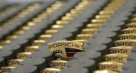 Car emblems for the new Porsche 918-Spyder are placed in a box at the production line of the German car manufacturer's plant in Stuttgart-Zu Car emblems for the new Porsche 918-Spyder are placed in a box at the production line of the German car manufacturer's plant in Stuttgart-Zu