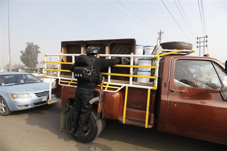 A police officer searches a vehicle at a checkpoint as security increases after a bomb attack, at Abu Ghraib district in west of Baghdad Jan A police officer searches a vehicle at a checkpoint as security increases after a bomb attack, at Abu Ghraib district in west of Baghdad Jan