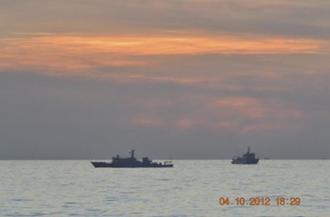 A handout photo shows two Chinese surveillance ships which sailed between a Philippines warship and eight Chinese fishing boats to prevent t A handout photo shows two Chinese surveillance ships which sailed between a Philippines warship and eight Chinese fishing boats to prevent t