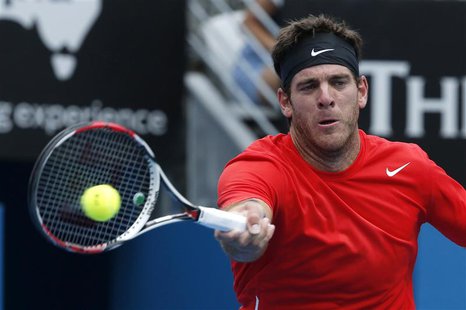 Juan Martin Del Potro of Argentina hits a return to Dmitry Tursunov of Russia during their men's singles semi-final match at the Sydney Inte Juan Martin Del Potro of Argentina hits a return to Dmitry Tursunov of Russia during their men's singles semi-final match at the Sydney Inte