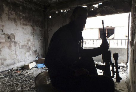 A Free Syrian Fighter holds his weapon inside a damaged building in the besieged area of Homs, January 4, 2014. REUTERS/Yazan Homsy A Free Syrian Fighter holds his weapon inside a damaged building in the besieged area of Homs, January 4, 2014. REUTERS/Yazan Homsy
