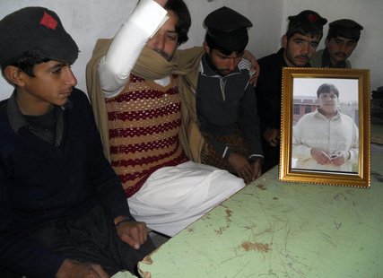 Mujtaba Hussan (2nd L), brother of Aitezaz Hassan who was killed in a suicide bomb attack, sits with students of the high school next to a f Mujtaba Hussan (2nd L), brother of Aitezaz Hassan who was killed in a suicide bomb attack, sits with students of the high school next to a f