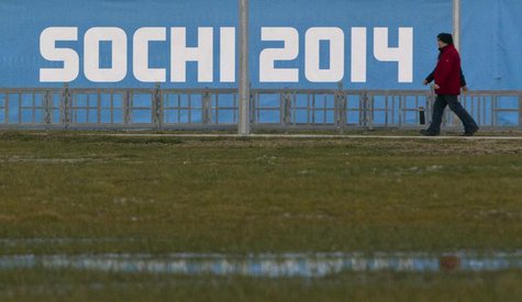 People walk past a banner near venues in the Olympic Park in Adler near Sochi, December 31, 2013. REUTERS/Maxim Shemetov People walk past a banner near venues in the Olympic Park in Adler near Sochi, December 31, 2013. REUTERS/Maxim Shemetov
