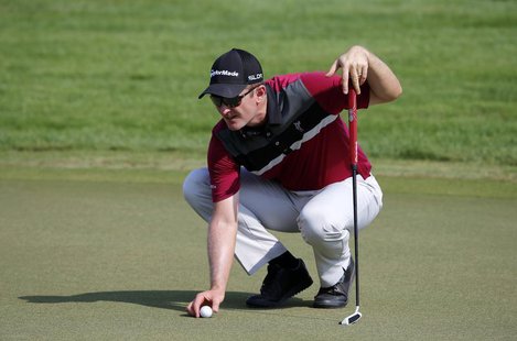 Justin Rose of England replaces the ball on the 10th green during the second round of the DP World Tour Championship in Dubai November 15, 2 Justin Rose of England replaces the ball on the 10th green during the second round of the DP World Tour Championship in Dubai November 15, 2